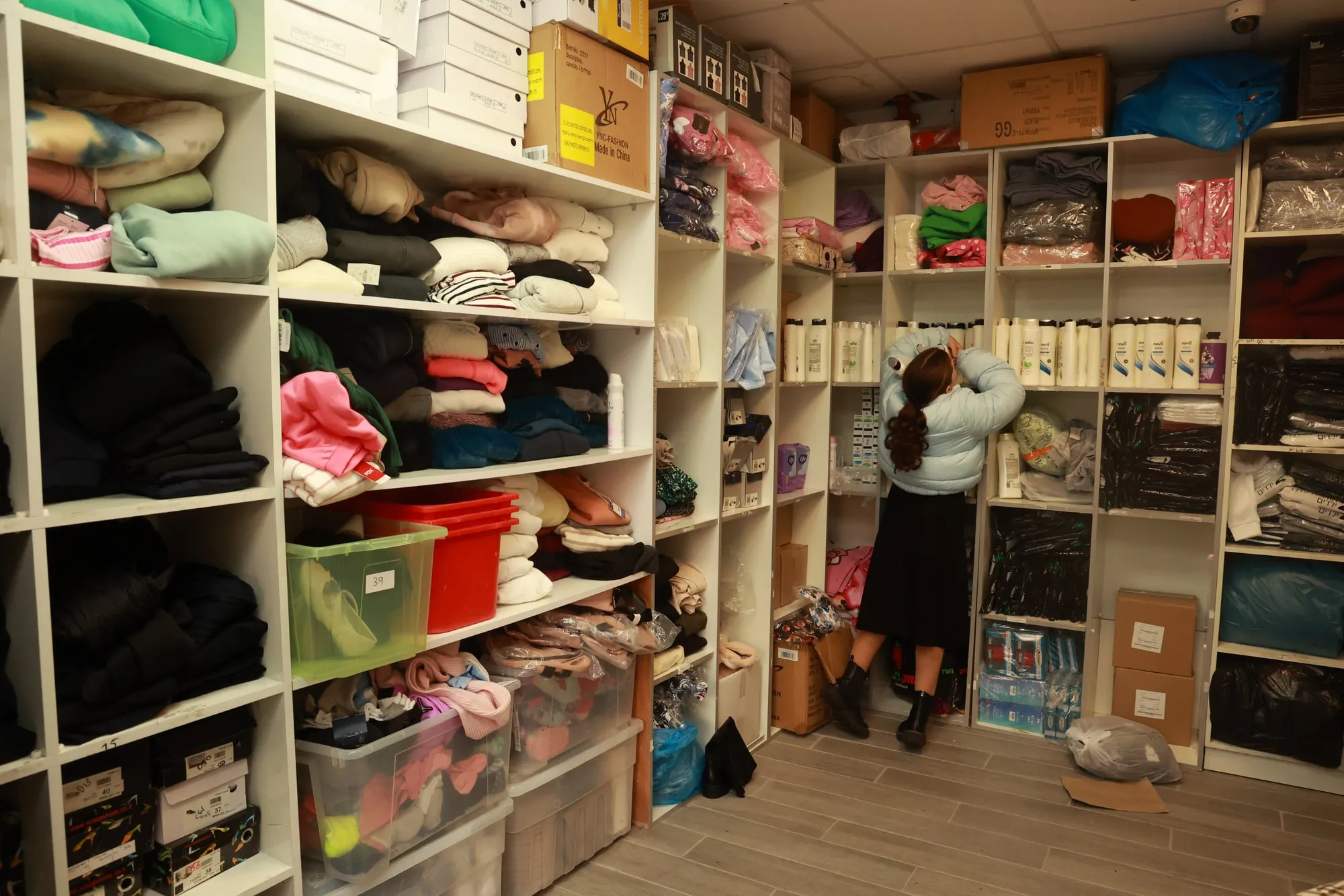 A girl choosing clothing in the Lev LaLev boutique